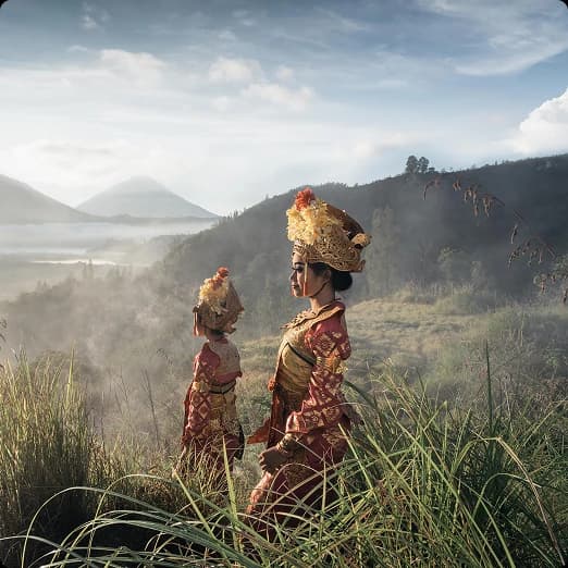 Mother and daughter overlooking a misty valley
